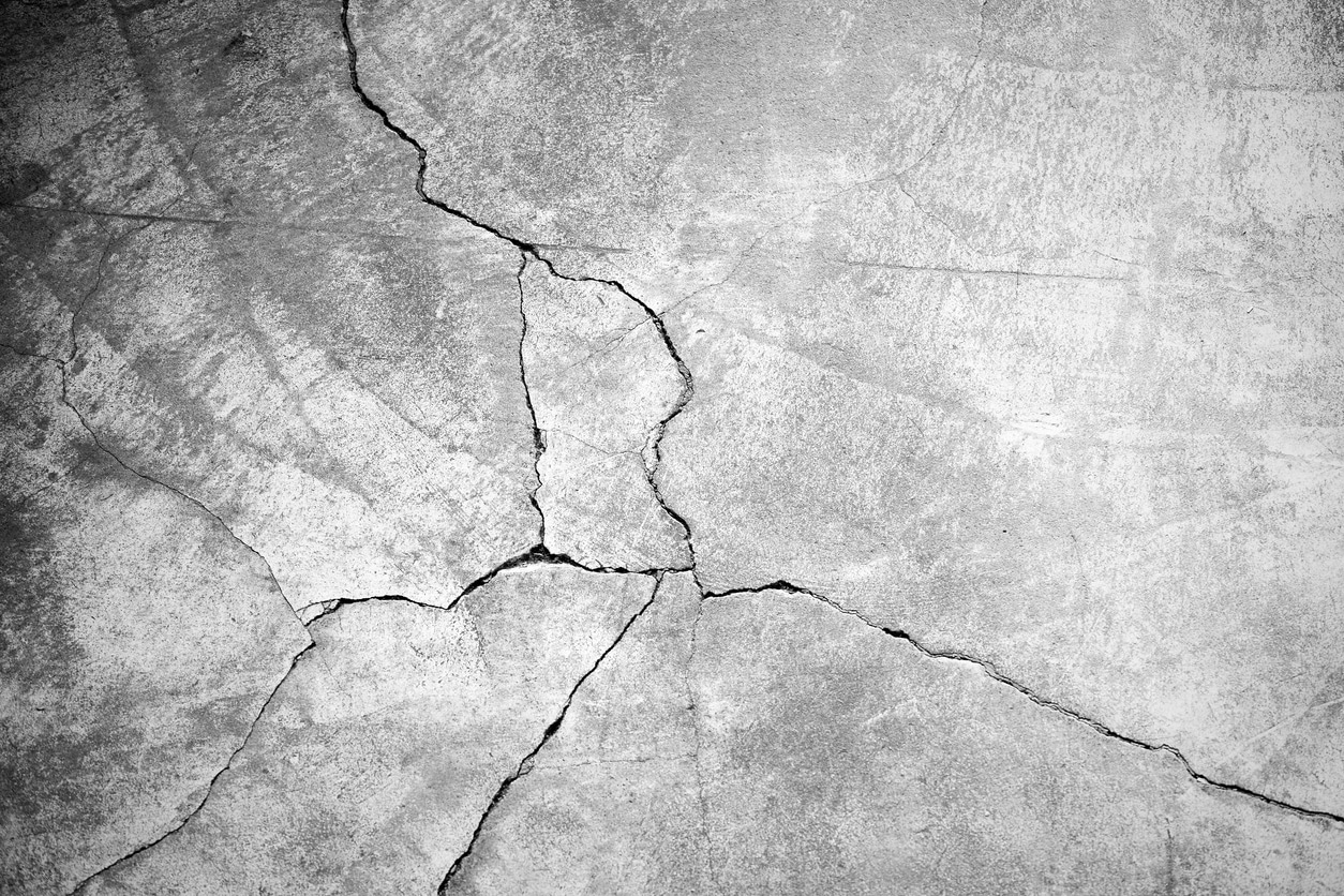 Large crack running through a concrete surface, an early sign of concrete cancer