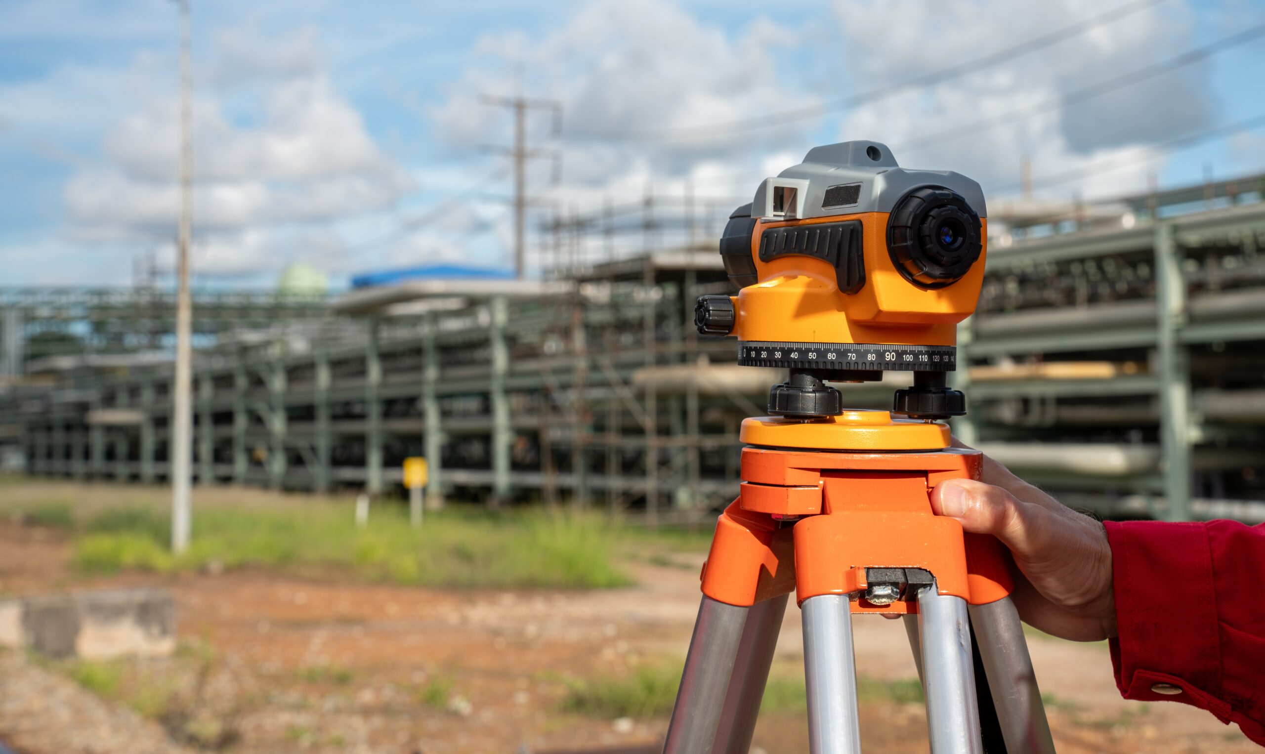 survey construction engineer with safety jacket use level survey camera.